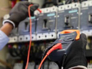 electrical-engineer-using-digital-multi-meter-checking-electric-current-voltage-circuit-breaker