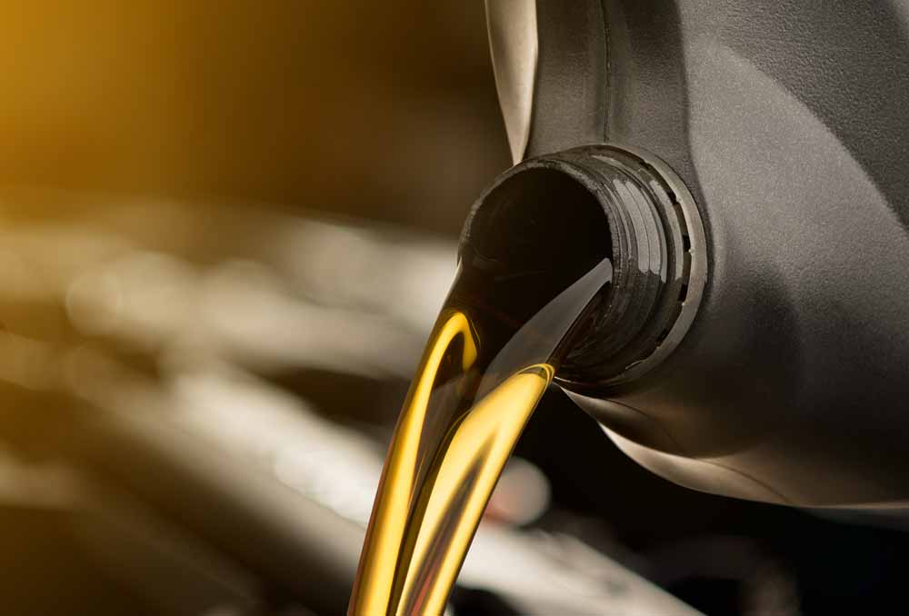 pouring-oil-lubricant-motor-car-from-black-bottle-isolated-white-background